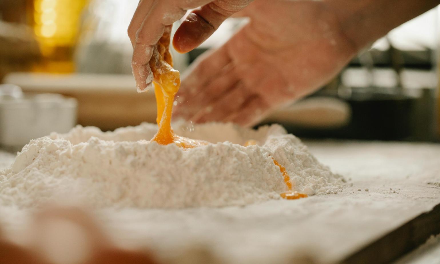 Hands working together in collaborative cooking environment